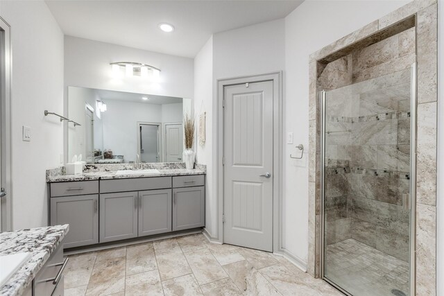 bathroom featuring vanity, recessed lighting, and a stall shower