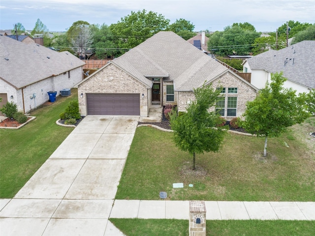 ranch-style house with a garage, brick siding, a shingled roof, and driveway