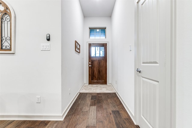 entryway with baseboards and dark wood-type flooring