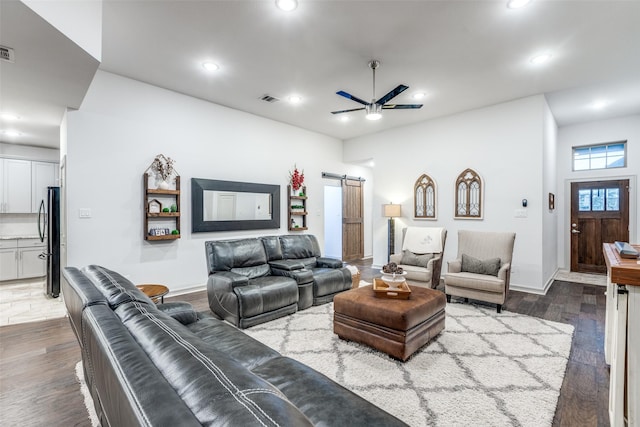 living room with visible vents, a barn door, dark wood-style floors, recessed lighting, and a ceiling fan