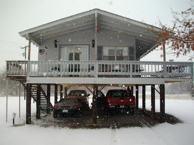 snow covered parking area with stairway