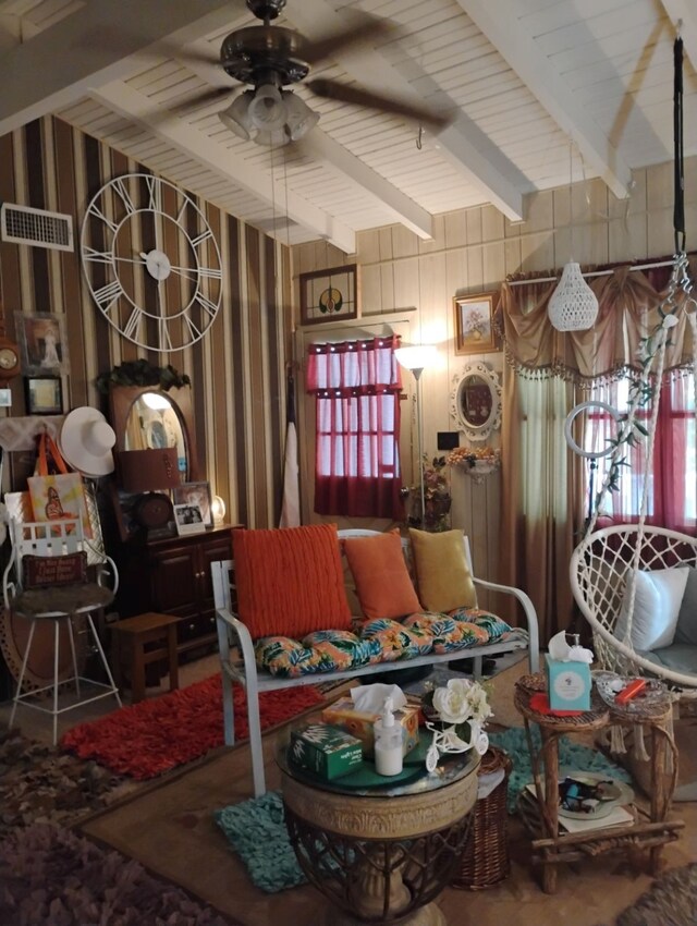 living room featuring visible vents, vaulted ceiling with beams, and a ceiling fan