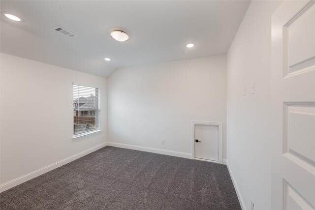 unfurnished room with recessed lighting, visible vents, dark colored carpet, and baseboards