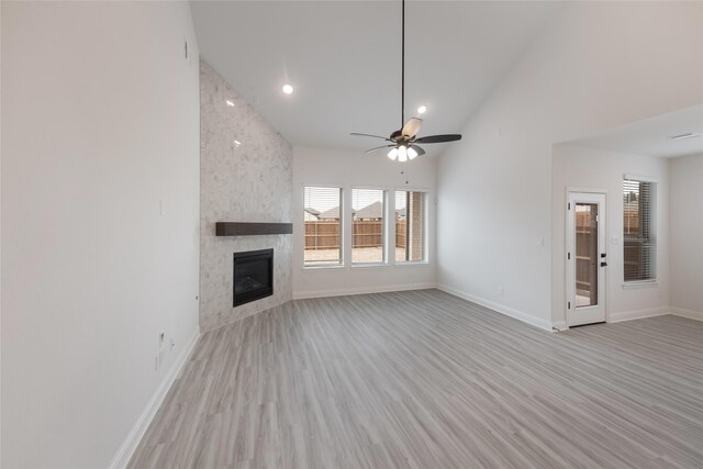 unfurnished living room with light wood finished floors, recessed lighting, a fireplace, ceiling fan, and baseboards