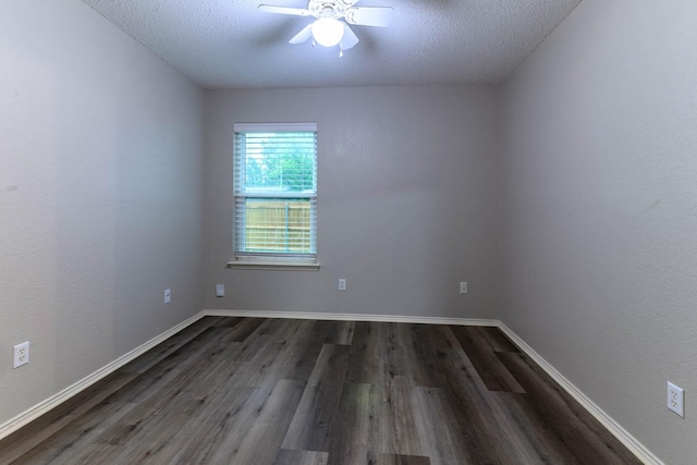 empty room featuring a textured ceiling, ceiling fan, and dark wood finished floors