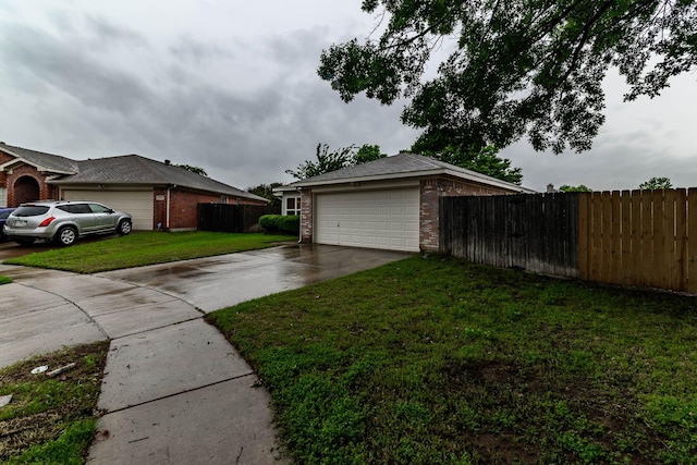 exterior space with concrete driveway, a lawn, fence, brick siding, and a garage