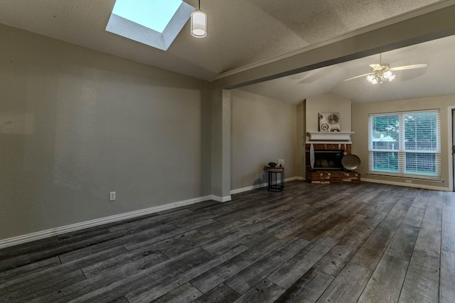 unfurnished living room featuring lofted ceiling with skylight, dark wood-style floors, and a fireplace