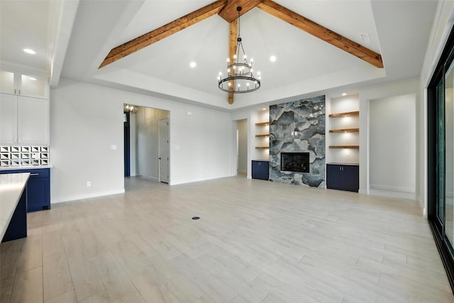 165 Rio Rancho Dr, Decatur, TX 76234 - unfurnished living room featuring a high end fireplace, a chandelier, recessed lighting, built in features, and light wood finished floors