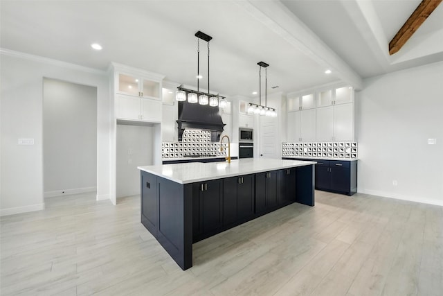 165 Rio Rancho Dr, Decatur, TX 76234 - kitchen with stainless steel microwave, light countertops, oven, backsplash, and white cabinetry