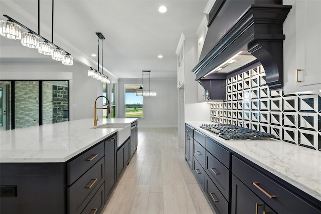 165 Rio Rancho Dr, Decatur, TX 76234 - kitchen with gas stovetop, custom exhaust hood, decorative backsplash, white cabinets, and light stone countertops