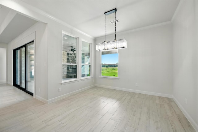 165 Rio Rancho Dr, Decatur, TX 76234 - unfurnished dining area with healthy amount of natural light, ornamental molding, light wood-style flooring, and a chandelier
