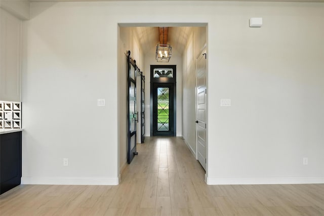 165 Rio Rancho Dr, Decatur, TX 76234 - entrance foyer featuring a barn door, light wood-style floors, a chandelier, and lofted ceiling