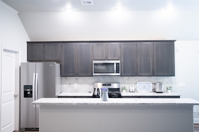 3919 Rose Hill Ct, Denison, TX 75020 - kitchen featuring tasteful backsplash, dark brown cabinetry, a kitchen island with sink, appliances with stainless steel finishes, and visible vents
