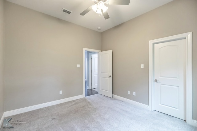 unfurnished bedroom with lofted ceiling, visible vents, ceiling fan, baseboards, and carpet