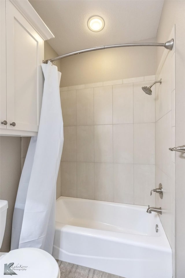full bathroom with toilet and shower / bath combination with curtain