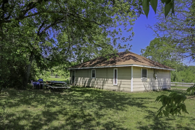 rear view of house with a yard
