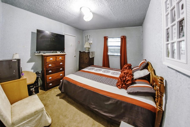 carpeted bedroom with a textured ceiling