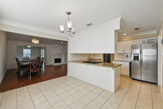 3836 Wedgworth Rd S, Fort Worth, TX 76133 - kitchen with an inviting chandelier, stainless steel fridge with ice dispenser, ornamental molding, visible vents, and light tile patterned flooring