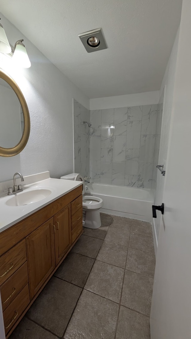 bathroom with a textured ceiling, toilet, shower / washtub combination, vanity, and tile patterned flooring