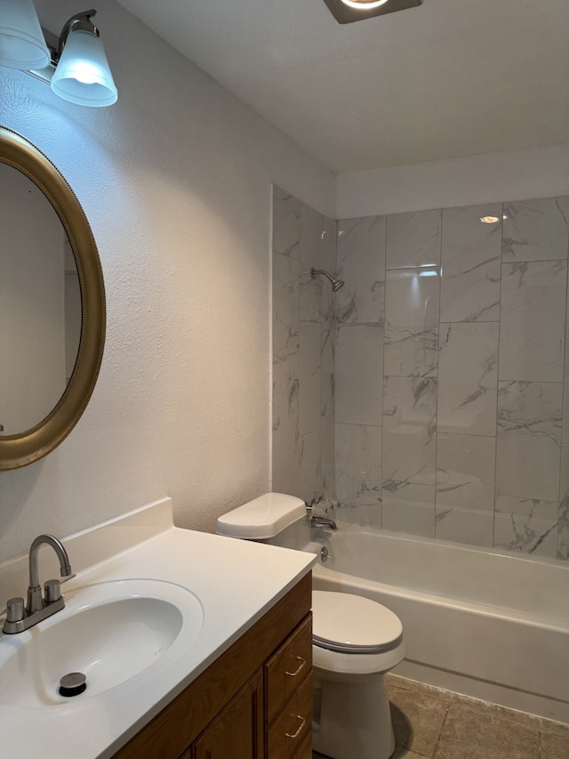full bathroom featuring toilet, tile patterned floors, washtub / shower combination, and vanity