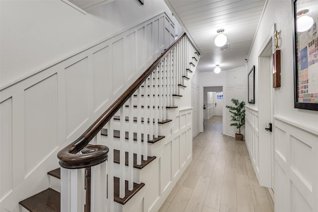 521 Texas St, Denton, TX 76209 - stairway with wood finished floors, wainscoting, a decorative wall, and visible vents