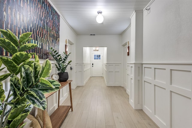 521 Texas St, Denton, TX 76209 - corridor with visible vents, ornamental molding, a decorative wall, light wood-style floors, and a wainscoted wall