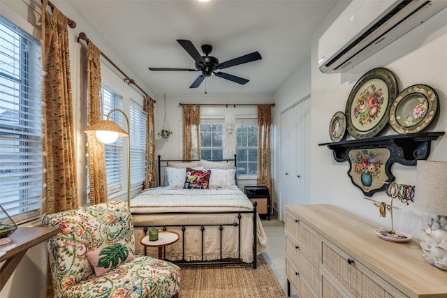 521 Texas St, Denton, TX 76209 - bedroom featuring a closet, a wall mounted AC, a ceiling fan, and light wood finished floors