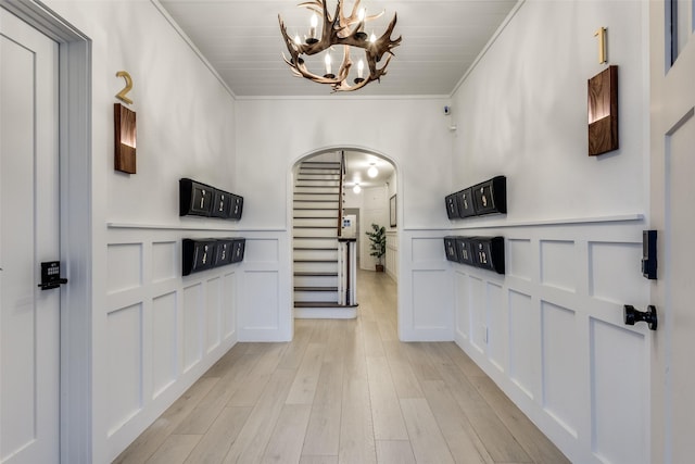 521 Texas St, Denton, TX 76209 - kitchen with crown molding, arched walkways, light wood finished floors, and a notable chandelier