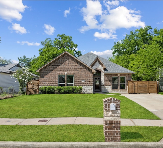 4435 Cicero St, Dallas, TX 75216 - french country style house with a front yard, fence, and brick siding