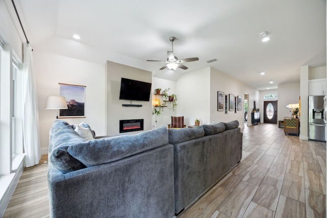 4435 Cicero St, Dallas, TX 75216 - living room with visible vents, ceiling fan, a glass covered fireplace, recessed lighting, and light wood finished floors