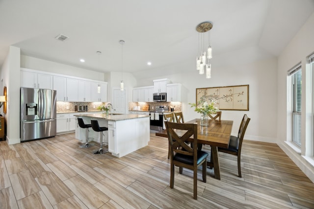 4435 Cicero St, Dallas, TX 75216 - dining area with visible vents, light wood-style floors, and recessed lighting