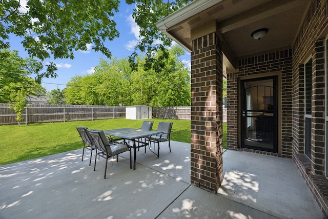 4435 Cicero St, Dallas, TX 75216 - view of patio with an outdoor structure, outdoor dining area, a fenced backyard, and a storage shed