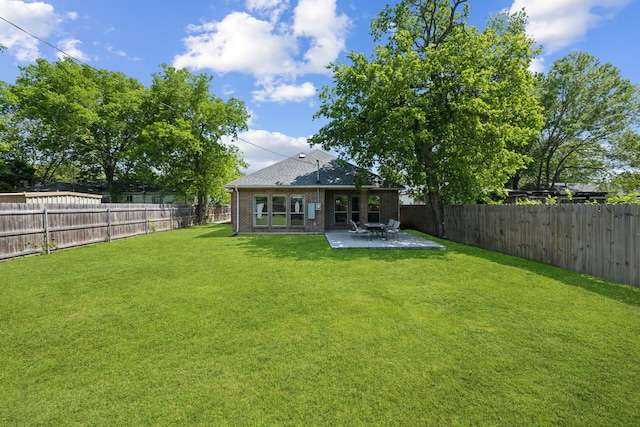 4435 Cicero St, Dallas, TX 75216 - rear view of property featuring a yard, a patio area, brick siding, and a fenced backyard