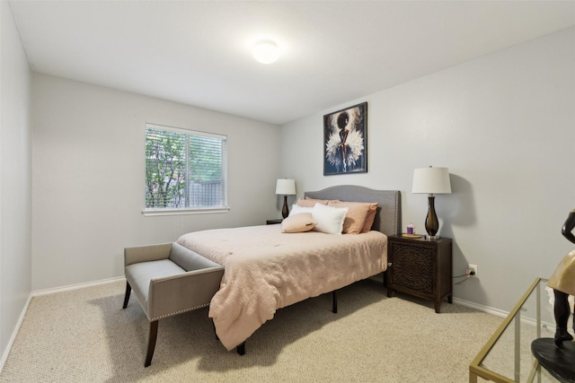 carpeted bedroom featuring baseboards