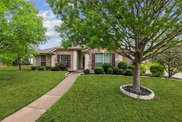 view of front of home featuring brick siding and a front lawn