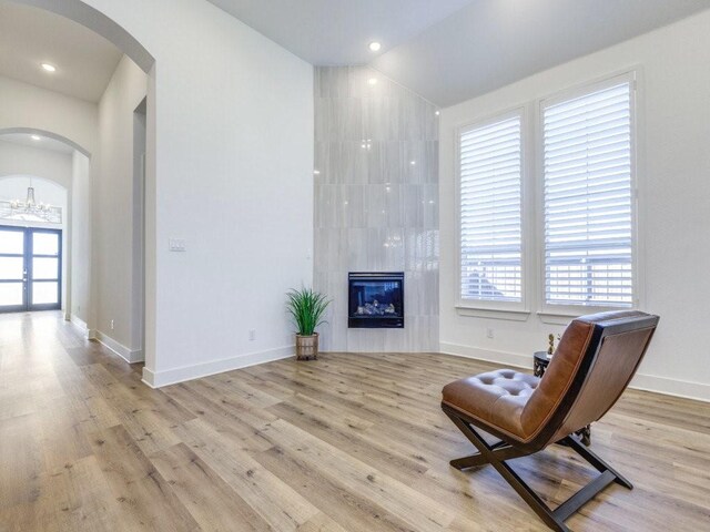 4124 Sandbrock Pkwy, Aubrey, TX 76227 - living area with wood finished floors, vaulted ceiling, and arched walkways