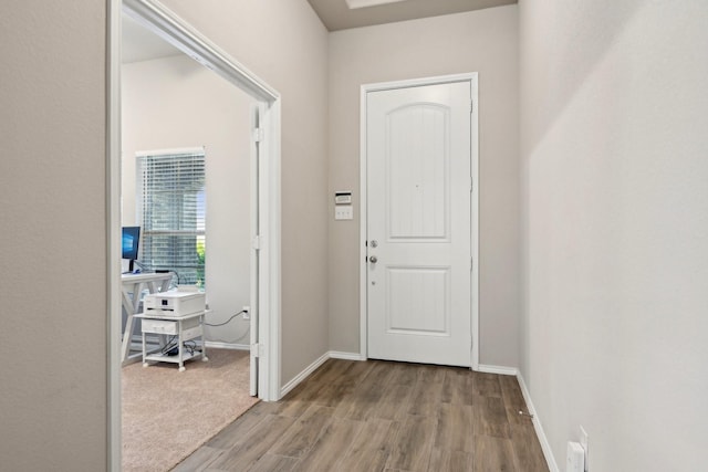 entryway with wood finished floors and baseboards