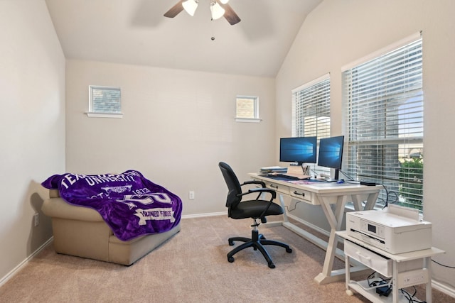 carpeted office space featuring plenty of natural light, a ceiling fan, vaulted ceiling, and baseboards