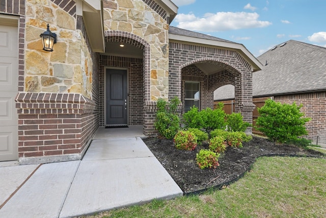 entrance to property with brick siding and stone siding