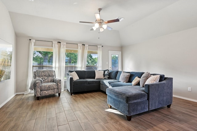 living area featuring ceiling fan, wood finished floors, lofted ceiling, and baseboards