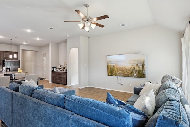 living room featuring wood finished floors, visible vents, a ceiling fan, and recessed lighting