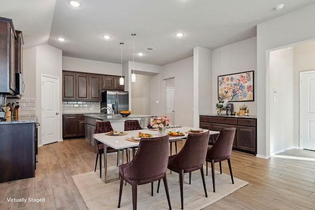 dining area featuring visible vents, recessed lighting, light wood-style flooring, and baseboards