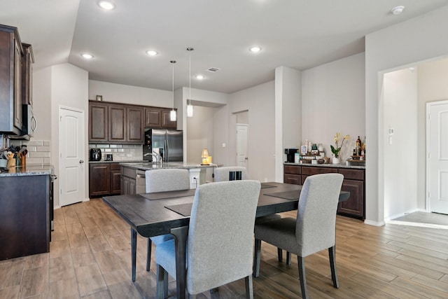 dining room with visible vents, recessed lighting, light wood finished floors, and baseboards