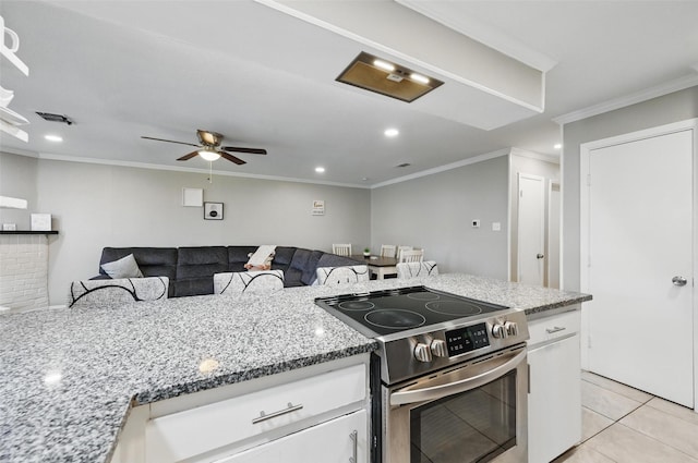 1501 SE 4th St, Grand Prairie, TX 75051 - kitchen featuring stainless steel electric range oven, white cabinetry, light stone countertops, crown molding, and ceiling fan