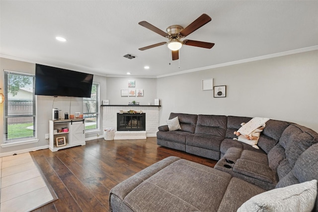 1501 SE 4th St, Grand Prairie, TX 75051 - living room with crown molding, ceiling fan, wood finished floors, recessed lighting, and a brick fireplace