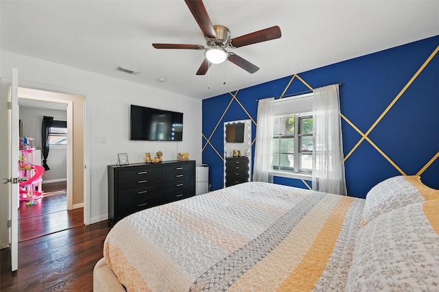 1501 SE 4th St, Grand Prairie, TX 75051 - bedroom with multiple windows, dark wood-type flooring, and ceiling fan