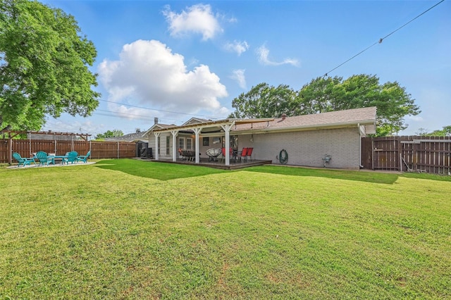 1501 SE 4th St, Grand Prairie, TX 75051 - rear view of property featuring a fenced backyard, a patio, a fire pit, and brick siding