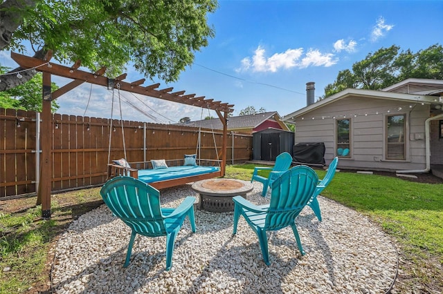 1501 SE 4th St, Grand Prairie, TX 75051 - fenced backyard with an outdoor fire pit, a storage unit, and a grill