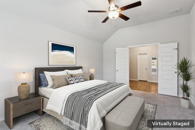 carpeted bedroom with visible vents, ceiling fan, vaulted ceiling, and baseboards