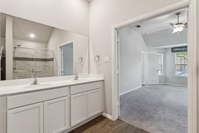 bathroom featuring baseboards, visible vents, a shower stall, and a sink